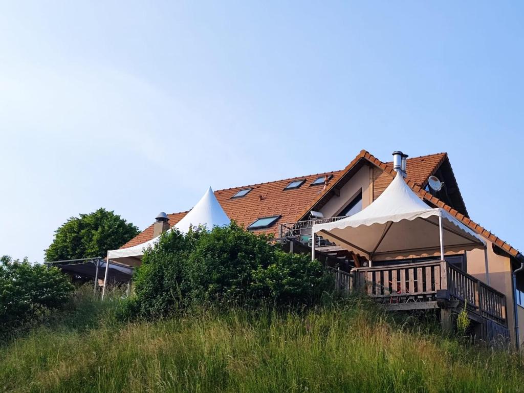dom na szczycie trawiastego wzgórza w obiekcie Auberge du Col du Festre w mieście Dévoluy