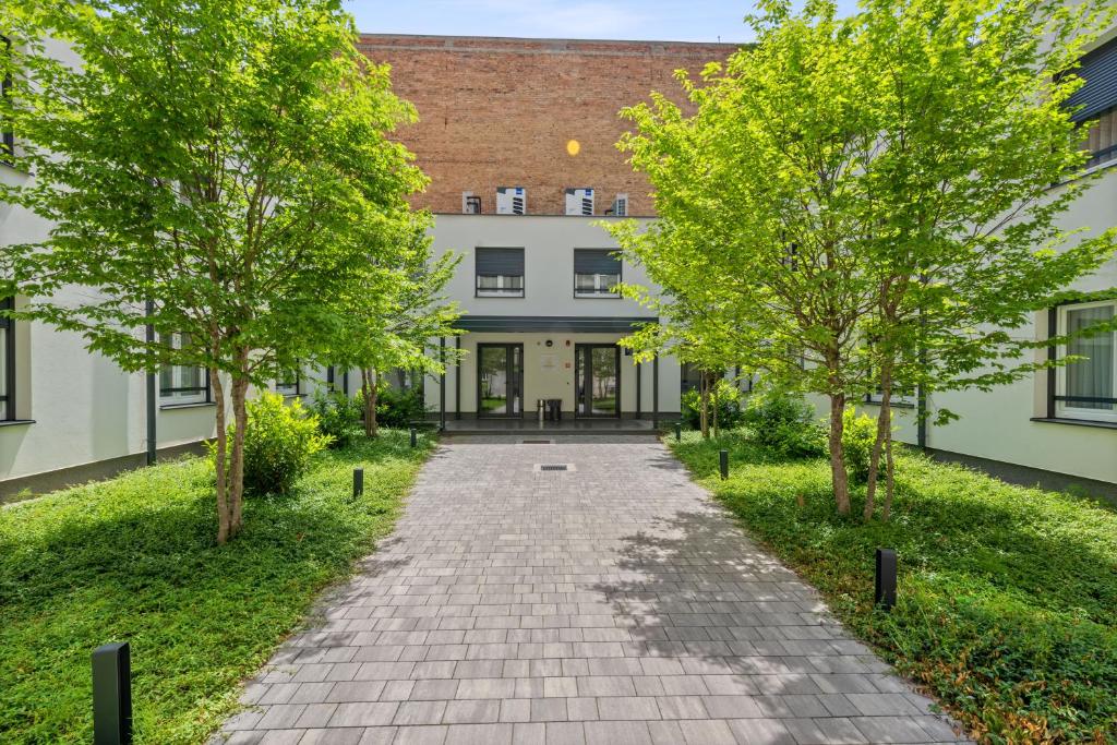 an empty pathway in front of a building at Studio Apartments Lenuzzi Zagreb in Zagreb