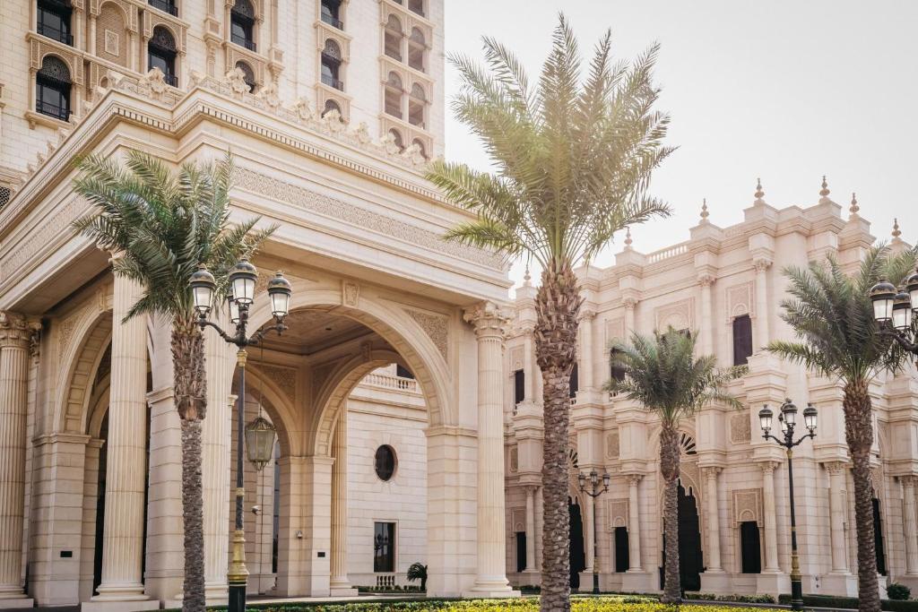 a building with palm trees in front of it at The Ritz-Carlton Jeddah in Jeddah