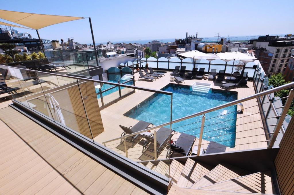 a balcony with a swimming pool on top of a building at Vicenza Hotel in Istanbul