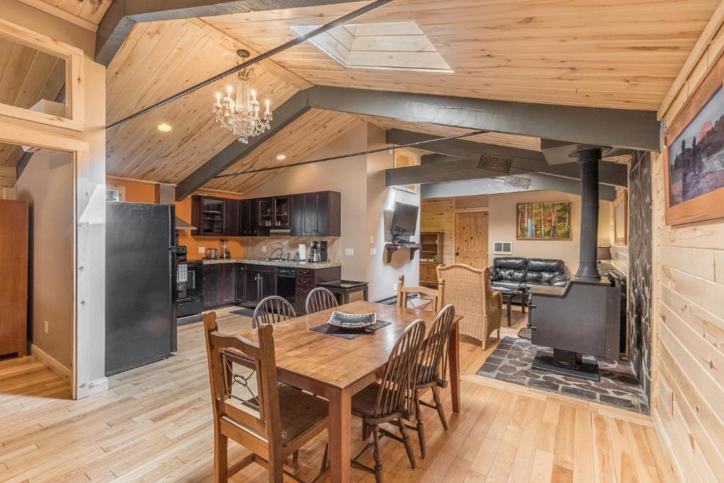 a kitchen and dining room with a wooden table and chairs at Lotus Mountain Suites The Gallery in Ouray