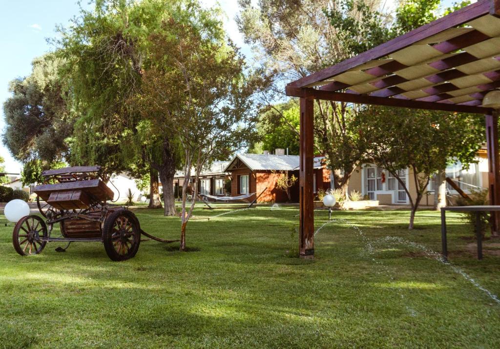 a carriage on the grass in a yard at Cabañas "El Valle" in San Rafael