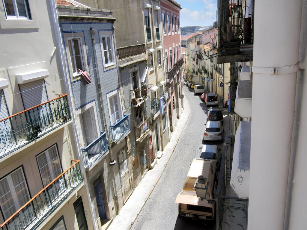 a city street with buildings and cars parked on the side at One bedroom apartement with wifi at Lisboa 5 km away from the beach in Lisbon