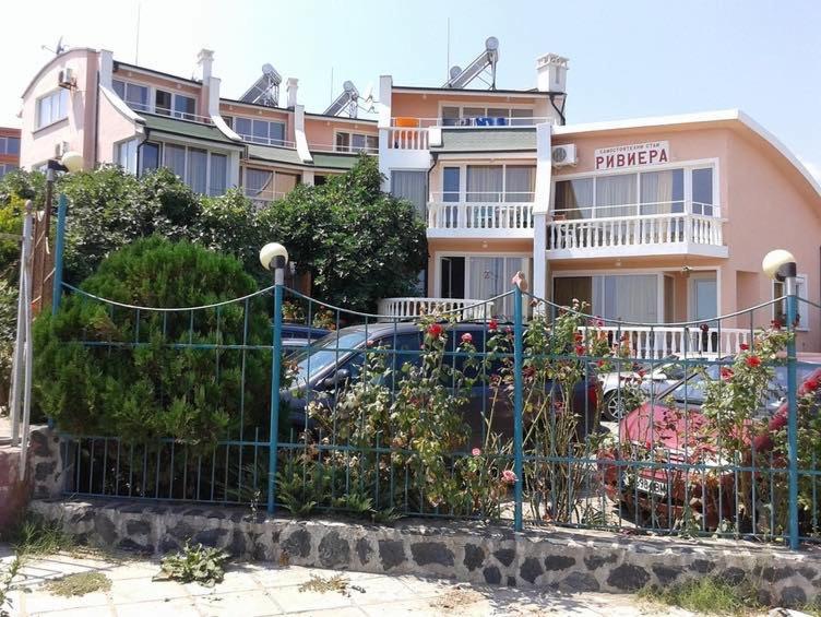 a fence in front of a building with a parking lot at Riviera Beach Hotel in Sozopol