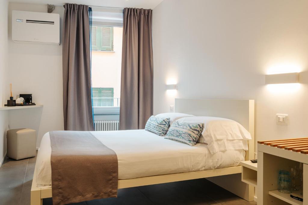 Postel nebo postele na pokoji v ubytování Oblò Portovenere Guesthouse