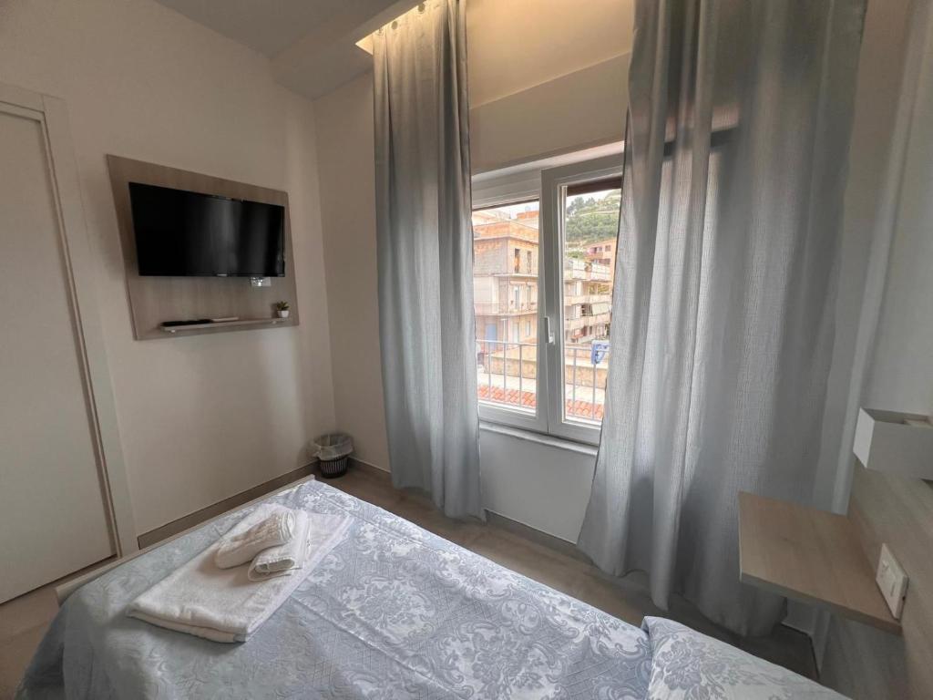 a hotel room with a bed and a window at Porta sul Mare in Tropea