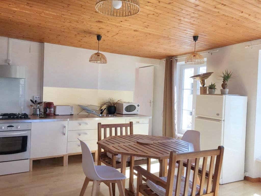 a kitchen and dining room with a table and chairs at Appartement d'une chambre avec vue sur la mer et wifi a Granville in Granville