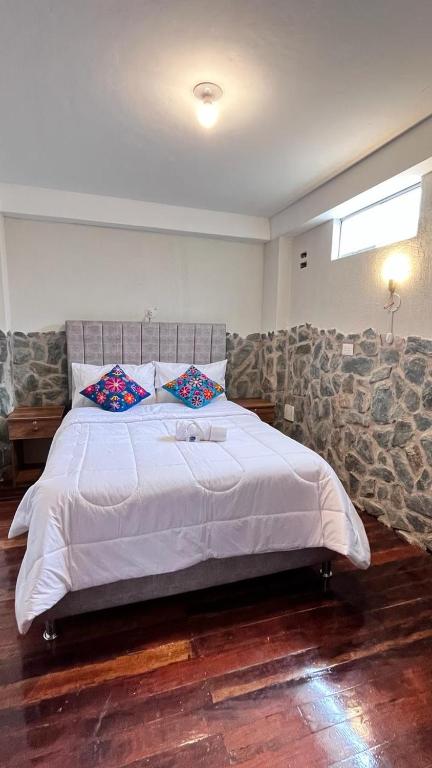 Postel nebo postele na pokoji v ubytování intikilla hostal