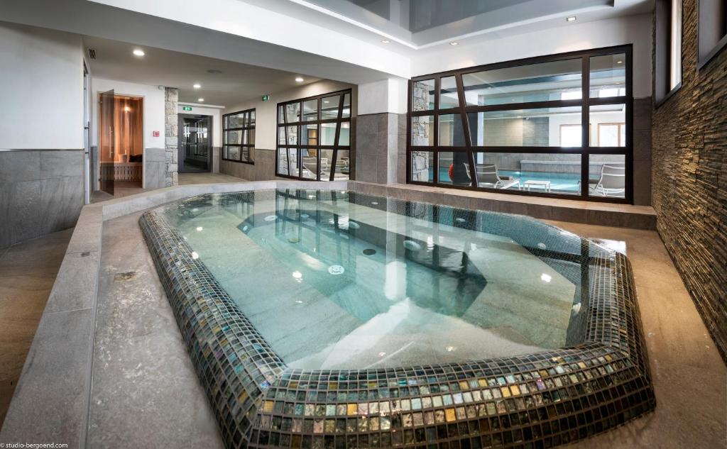 a large swimming pool in a house at Le Roc Des Tours in Le Grand-Bornand