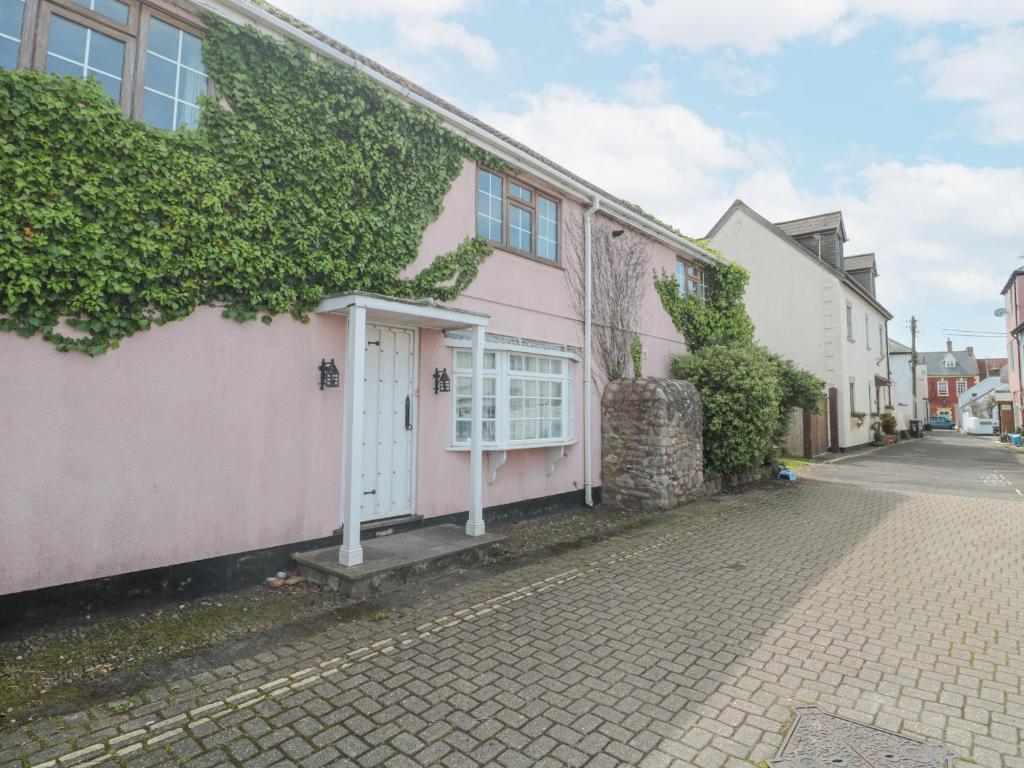 a pink house on the side of a street at The Cottage in Watchet