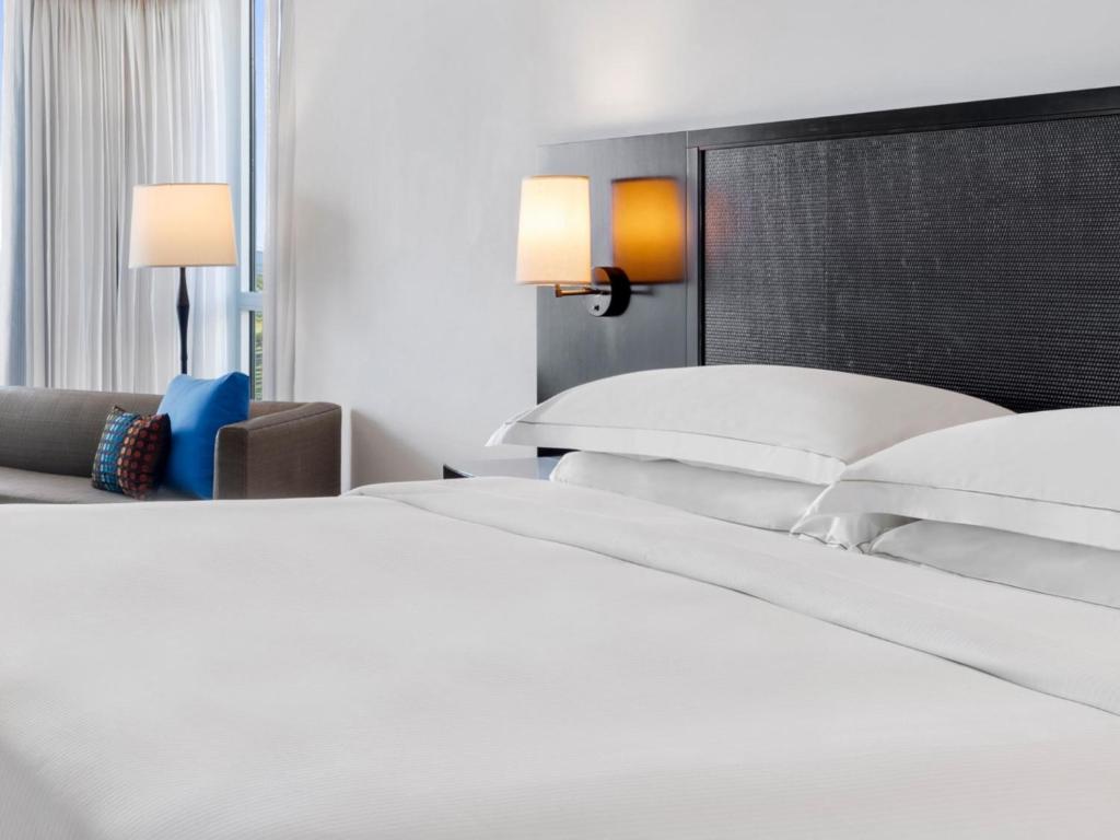 Una cama o camas en una habitación de Dreams Rose Hall All-Inclusive Resort & Spa