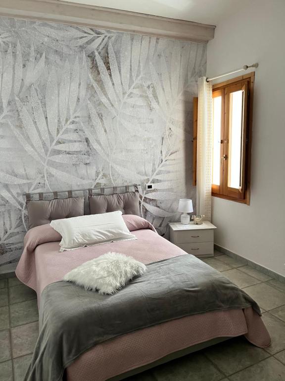 Postel nebo postele na pokoji v ubytování B&B Roseddu