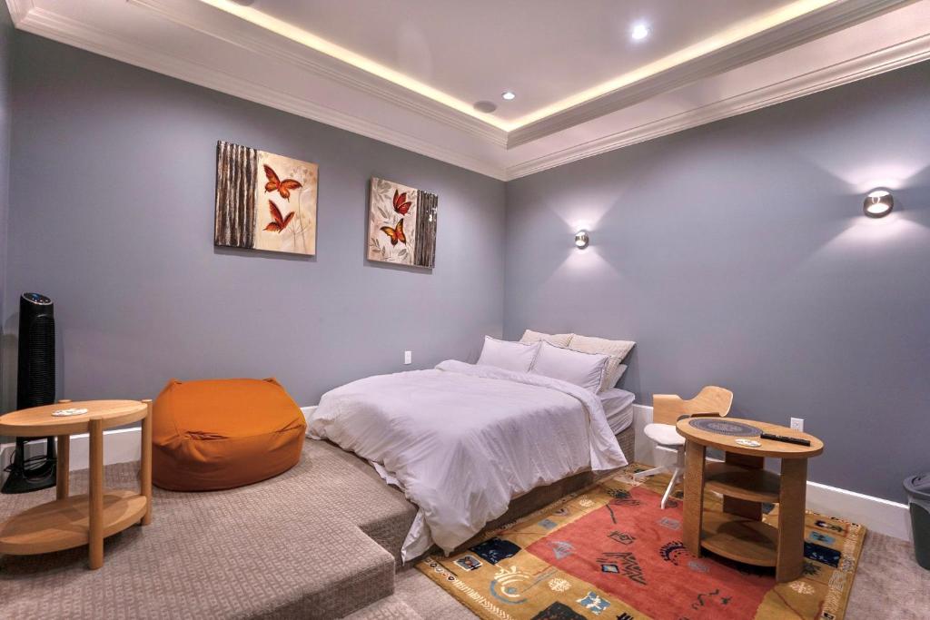 a bedroom with a bed and two tables at Balaclava Park House close UBC and Downtown in Vancouver