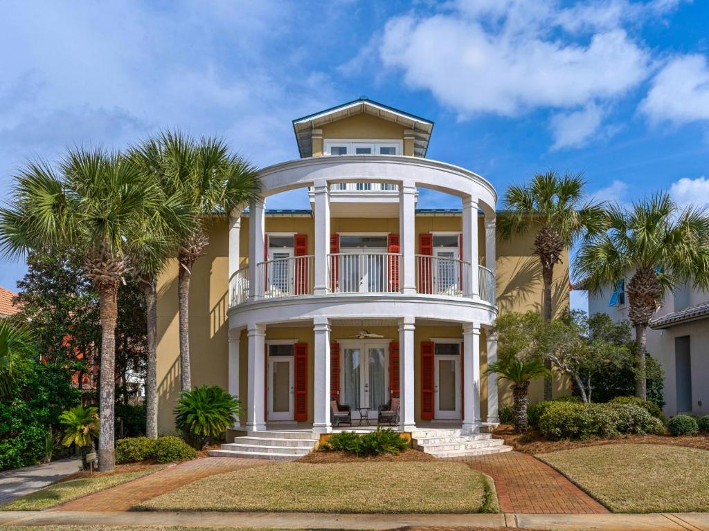 a large house with palm trees in front of it at Soleil Levant by Newman-Dailey in Destin