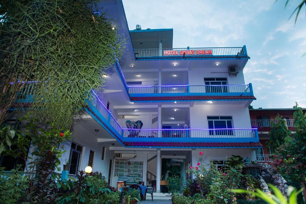 a white building with a sign on it at Hotel Shiva's Dream in Sauraha