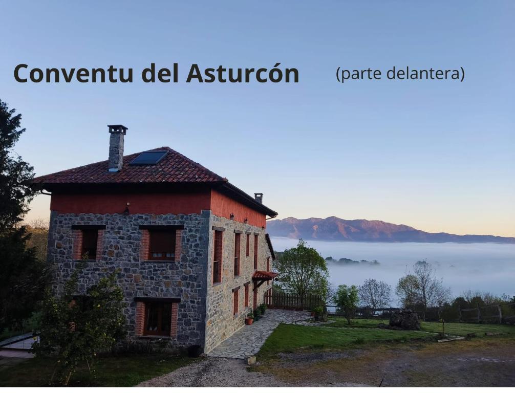 a building on a hill with a view of the ocean at El Conventu del Asturcon in Lago