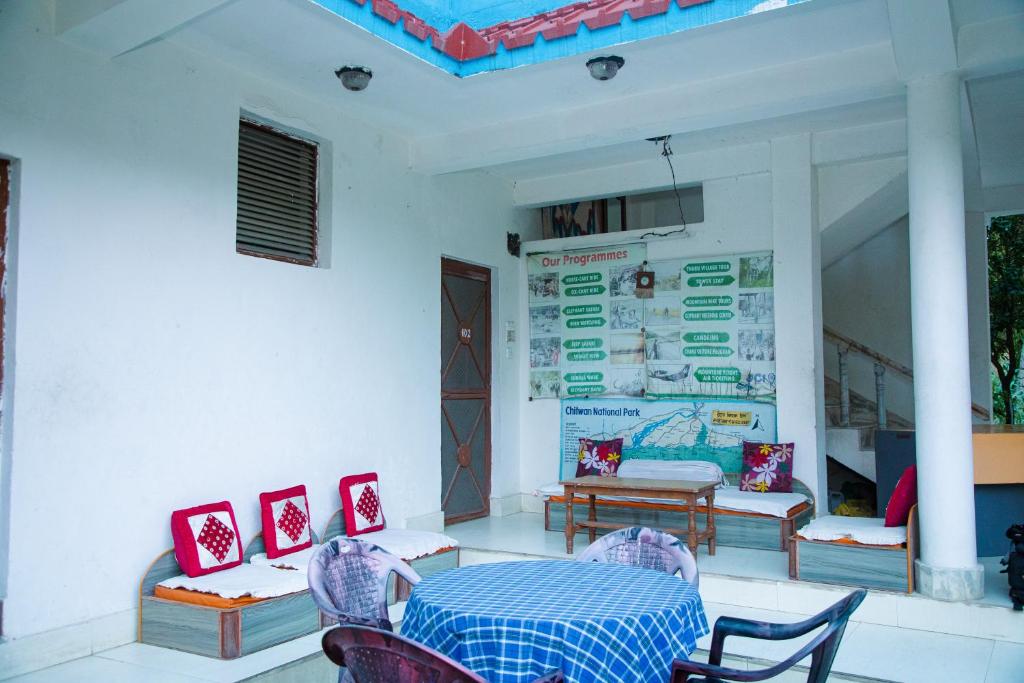 a dining room with a table and chairs in a room at Hotel Shiva's Dream in Sauraha