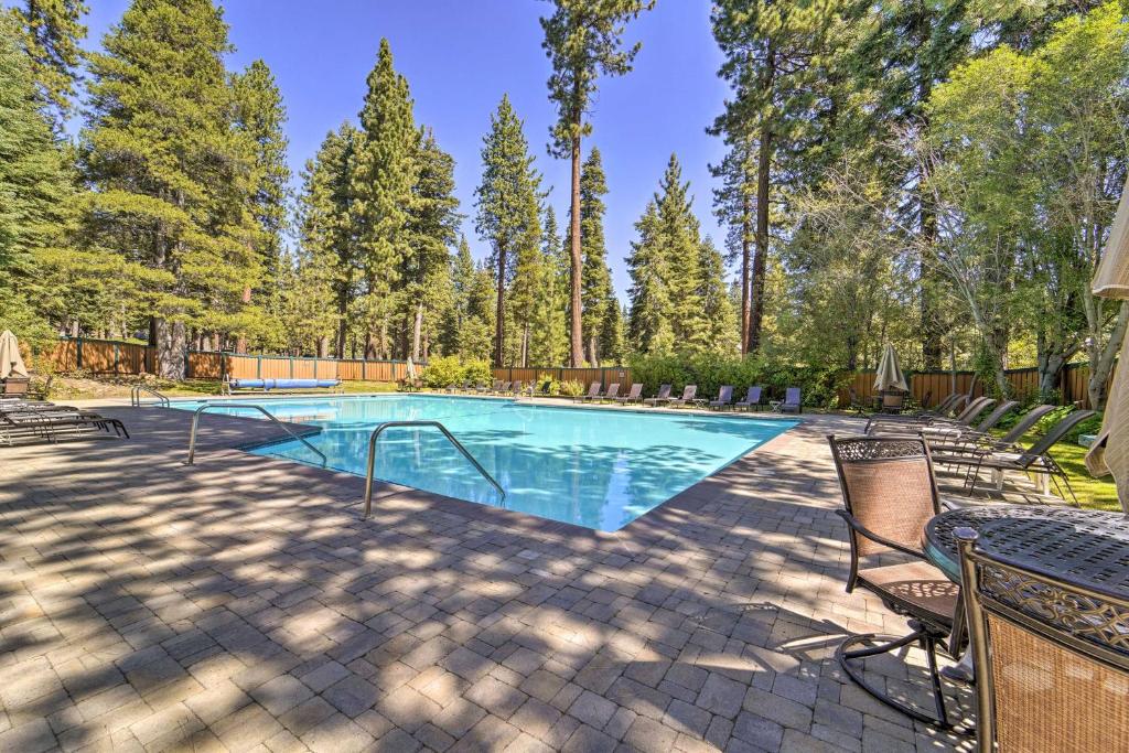 a swimming pool in a yard with chairs and trees at Steps to Lake Scenic Carnelian Bay Retreat in Carnelian Bay