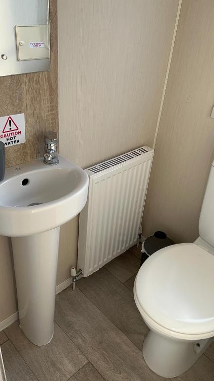 łazienka z białą umywalką i toaletą w obiekcie MOONSTONE Lymington w mieście Leysdown-on-Sea