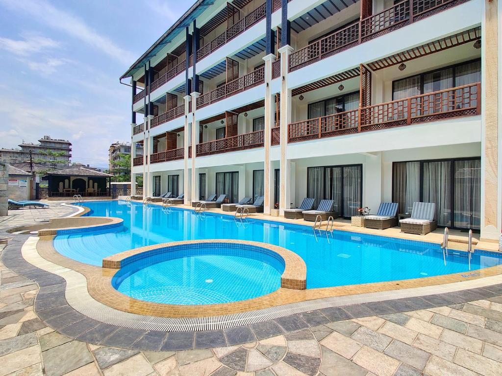 a large swimming pool in front of a building at Lake View Resort in Pokhara