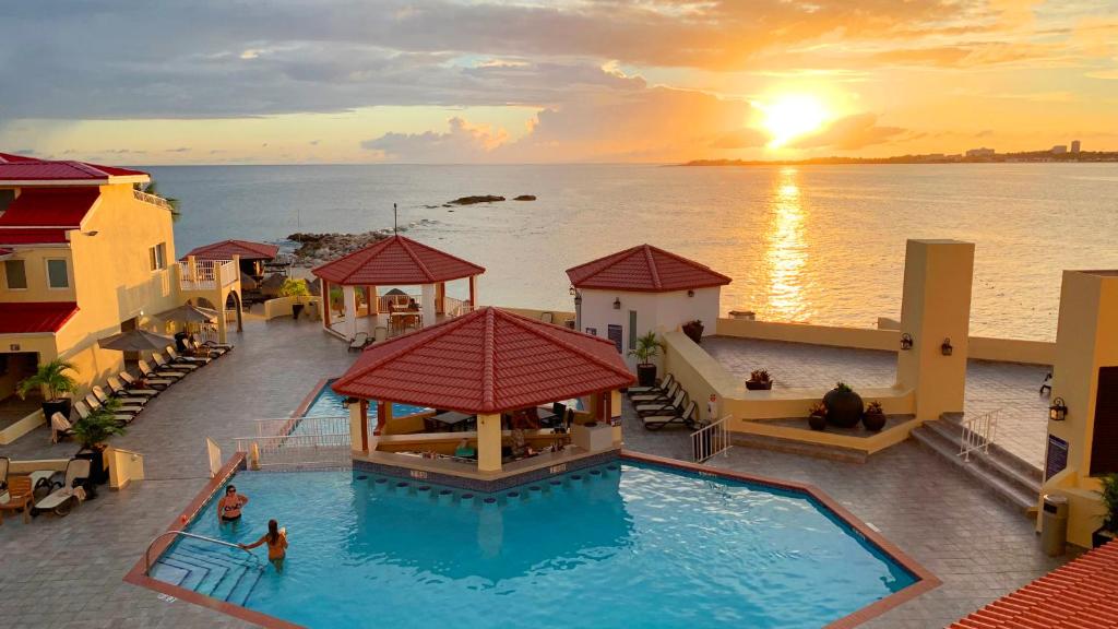an overhead view of a swimming pool with a sunset at Simpson Bay Resort Marina & Spa in Simpson Bay