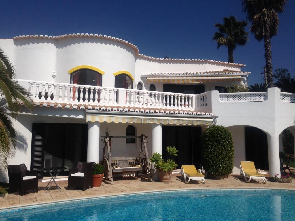 a large white house with a swimming pool at Villa Tobias in Carvoeiro