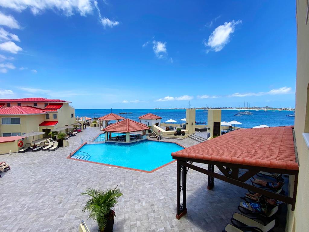 a swimming pool with a view of the ocean at Simpson Bay Resort Marina & Spa in Simpson Bay
