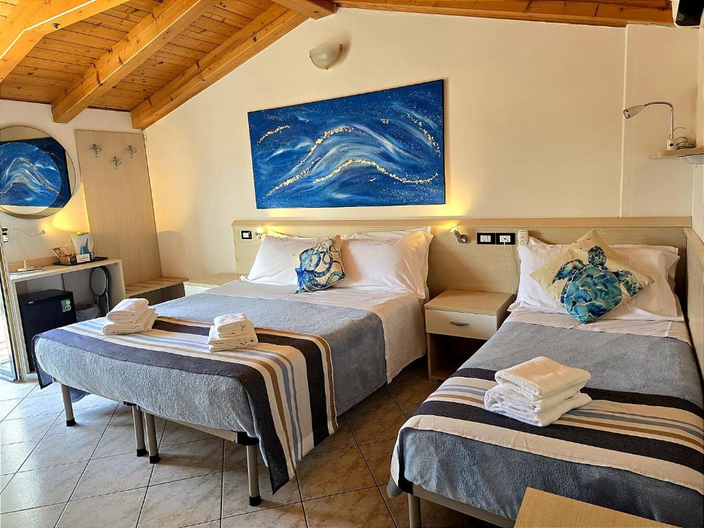 Postel nebo postele na pokoji v ubytování Hotel Orchidea