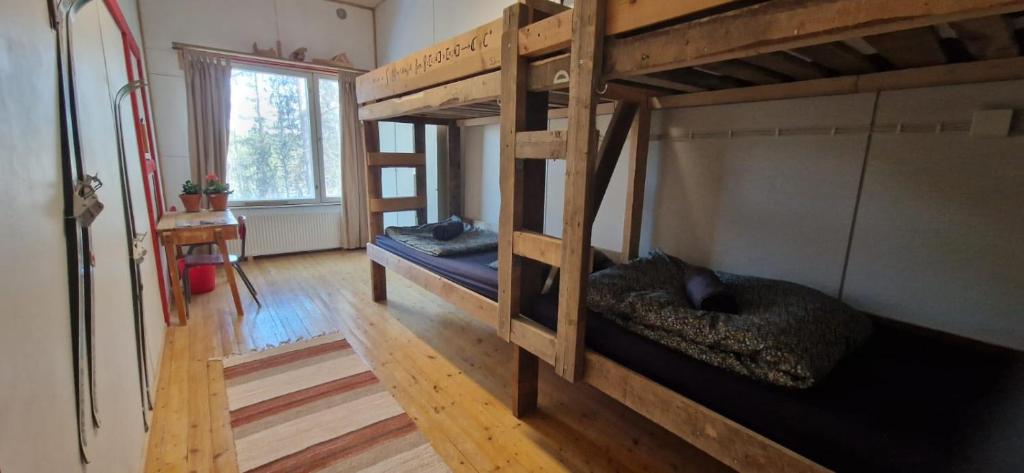 a room with two bunk beds in a house at Lapland Old School in Muonio