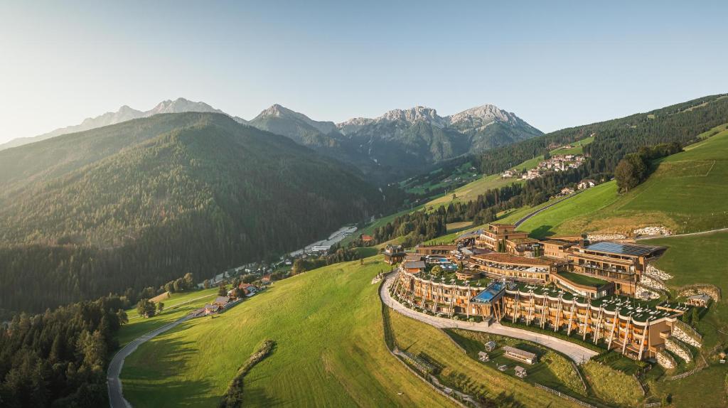 an aerial view of a resort in the mountains at Alpin Panorama Hotel Hubertus in Valdaora