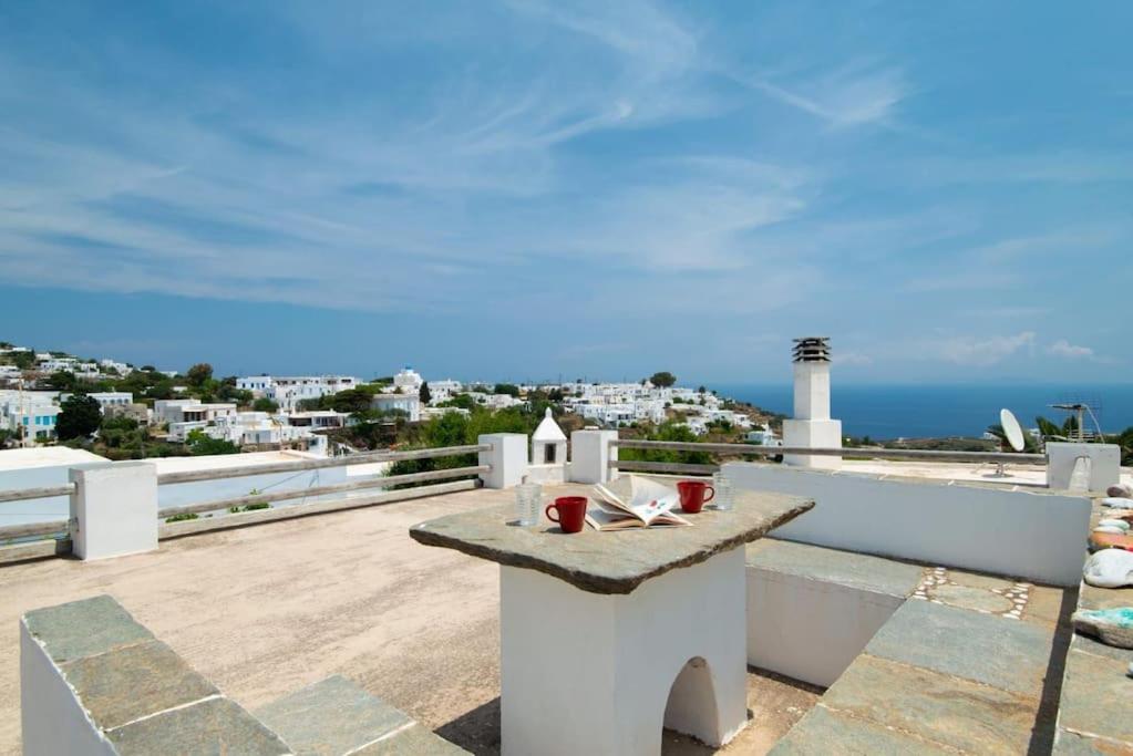 a balcony with a table and a view of the ocean at Sunrise balcony in Sifnos