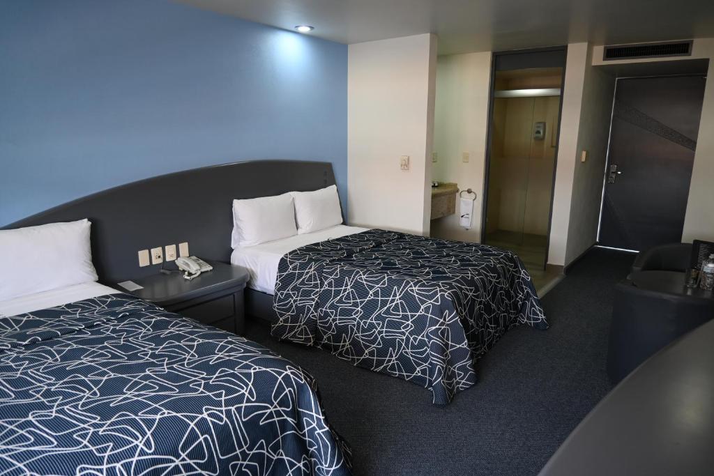 Voodi või voodid majutusasutuse Hotel Concorde Toluca toas