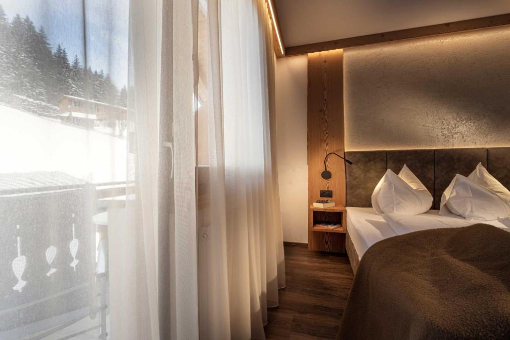 Postel nebo postele na pokoji v ubytování Almhotel Lenz