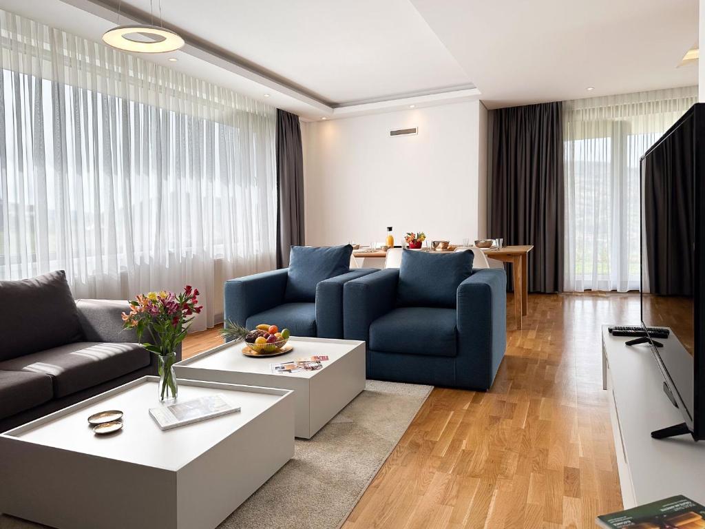 a living room with two blue couches and a table at Poljine Hills in Poljine
