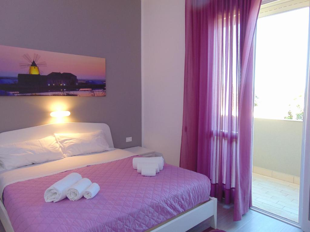 a bedroom with a bed with two towels on it at Residence Le Isole in Marsala