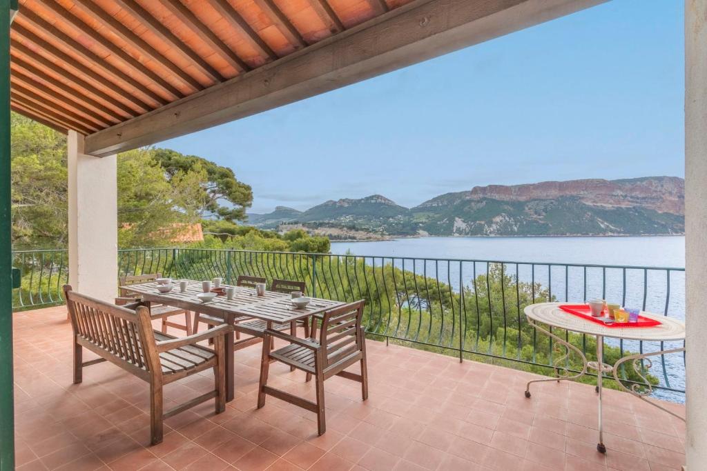a patio with a table and chairs and a view of the water at Le Panorama de Cassis - Welkeys in Cassis