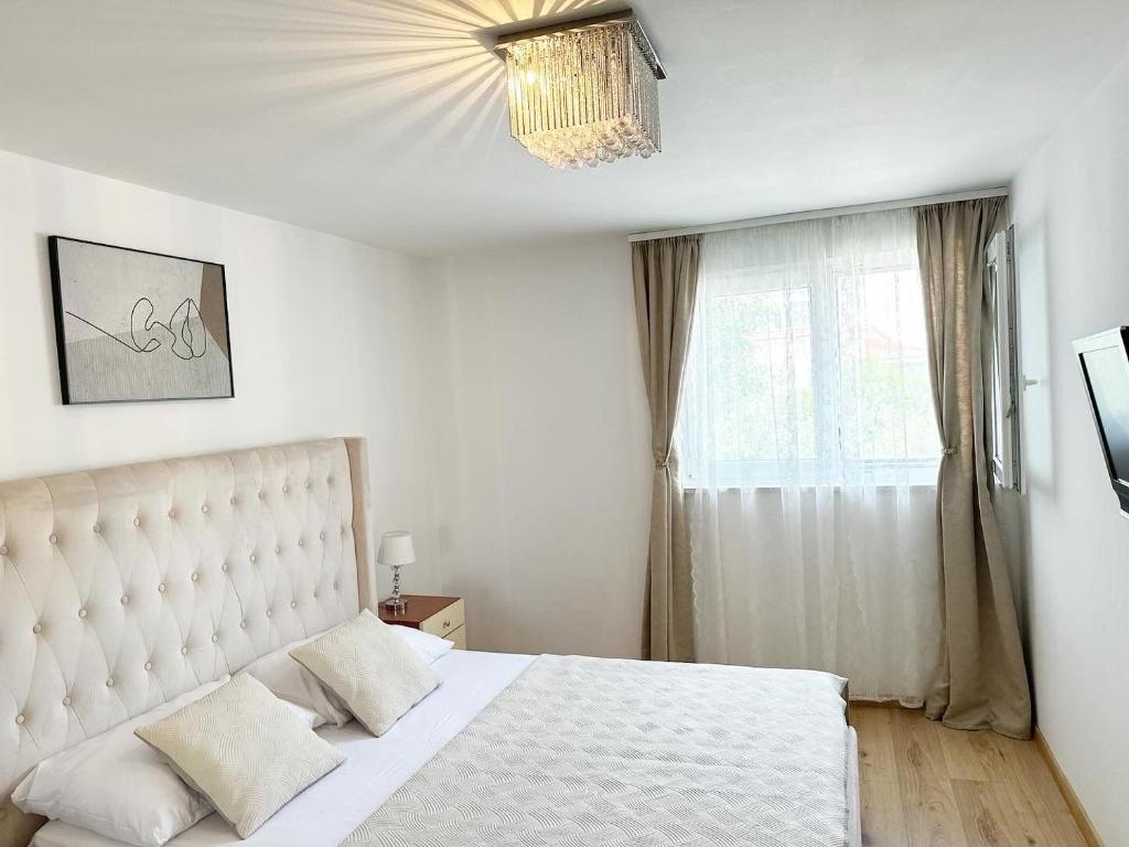 a bedroom with a white bed and a window at Apartment Matea in Split