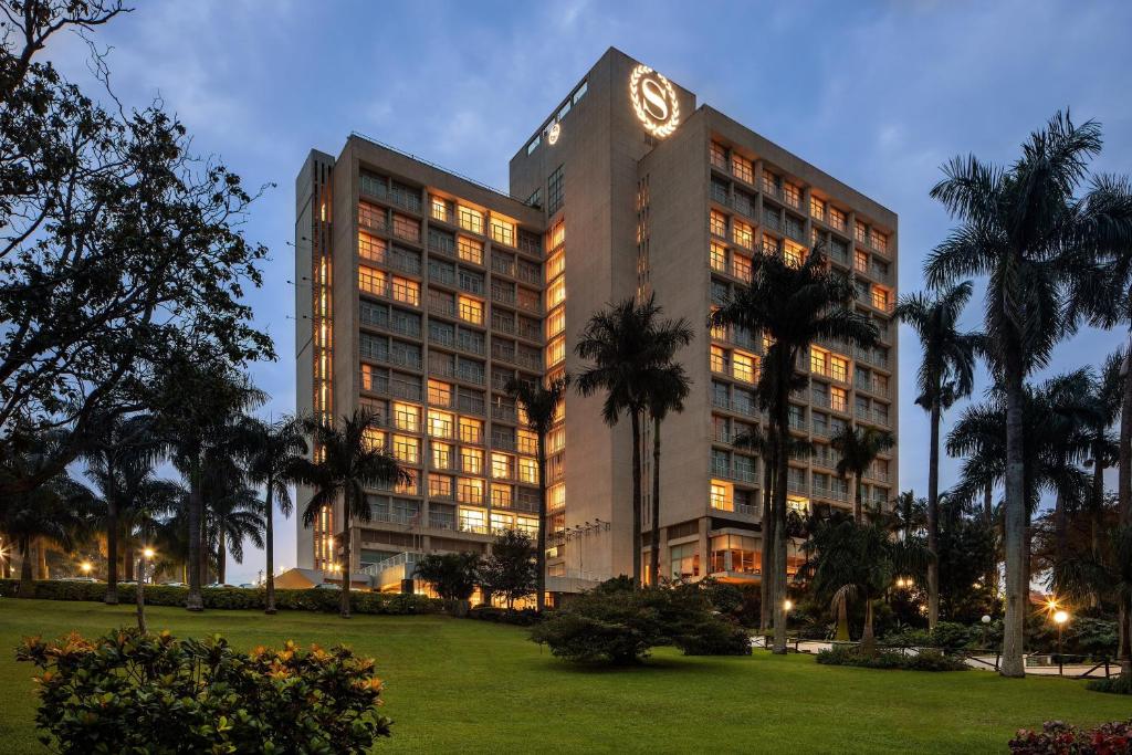 a tall building with a clock on top of it at Sheraton Kampala Hotel in Kampala