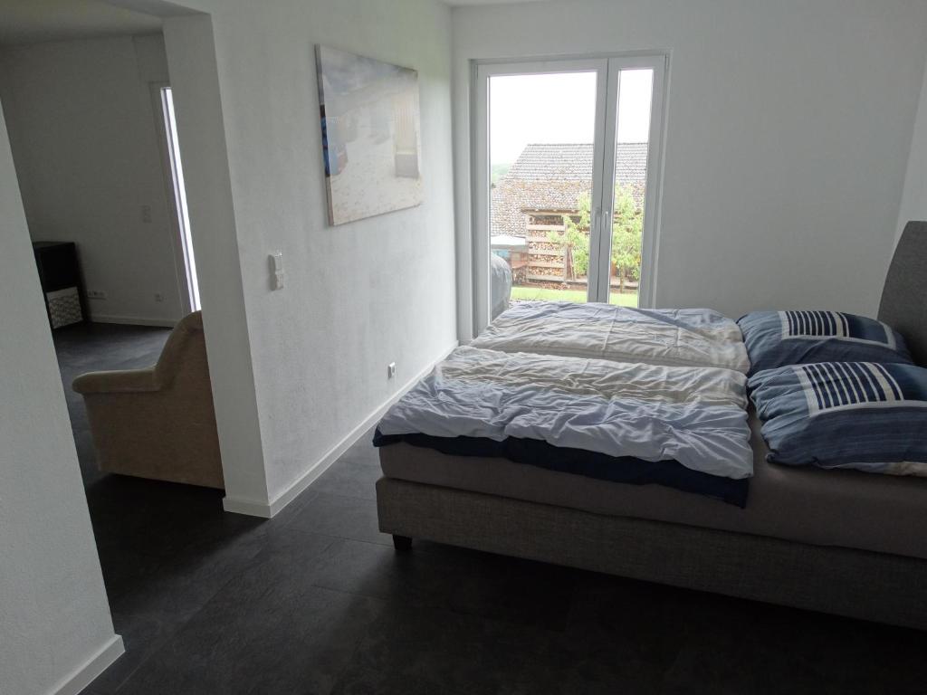 a bedroom with a bed and a window with a view at Urlaub in Horn in Horn