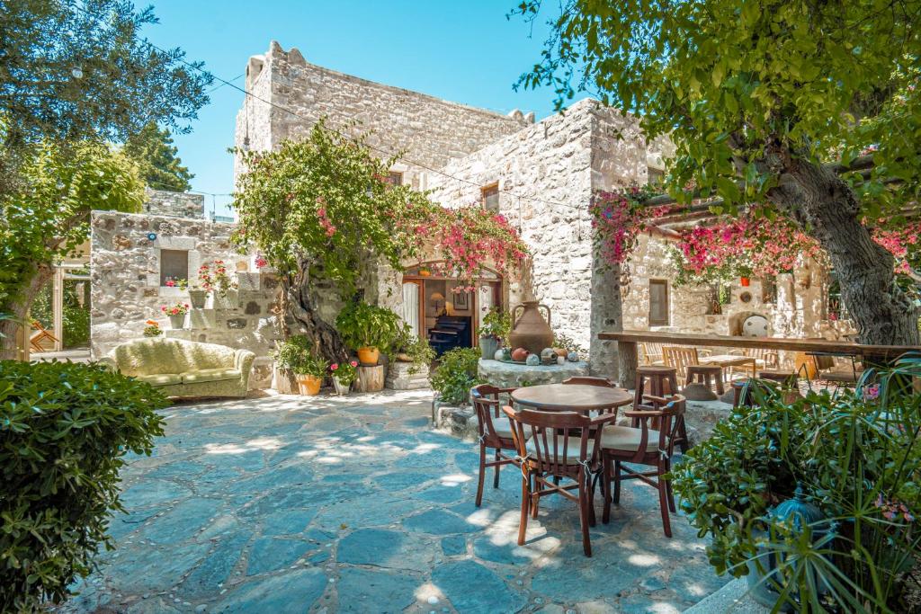 a stone house with a table and chairs at Ha La Bodrum in Bodrum City