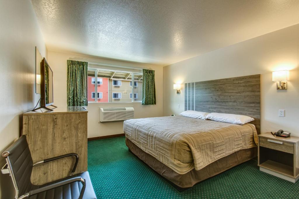 una camera d'albergo con letto e sedia di Coachman Inn a Bellingham