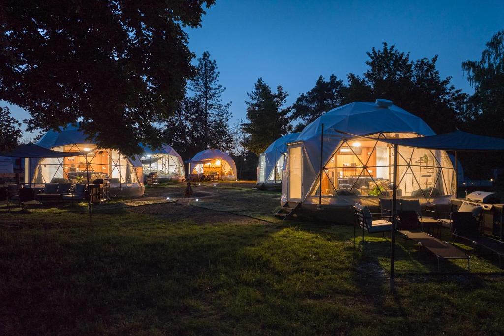 a group of tents in a field at night at Glamping Slapy in Slapy