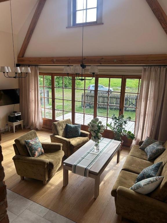 a living room with couches and a coffee table at Nadbużański Świt Granne in Perlejewo