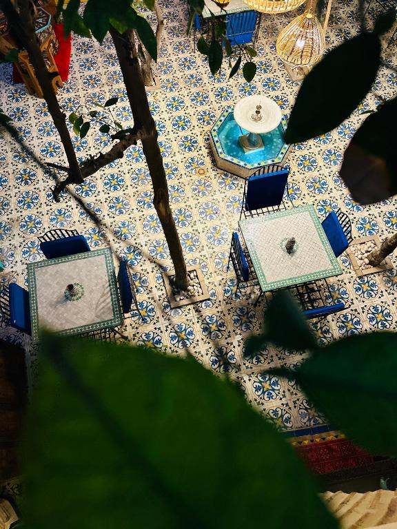 an overhead view of a table with blue and white tiles at Riad Al Nour in Marrakech