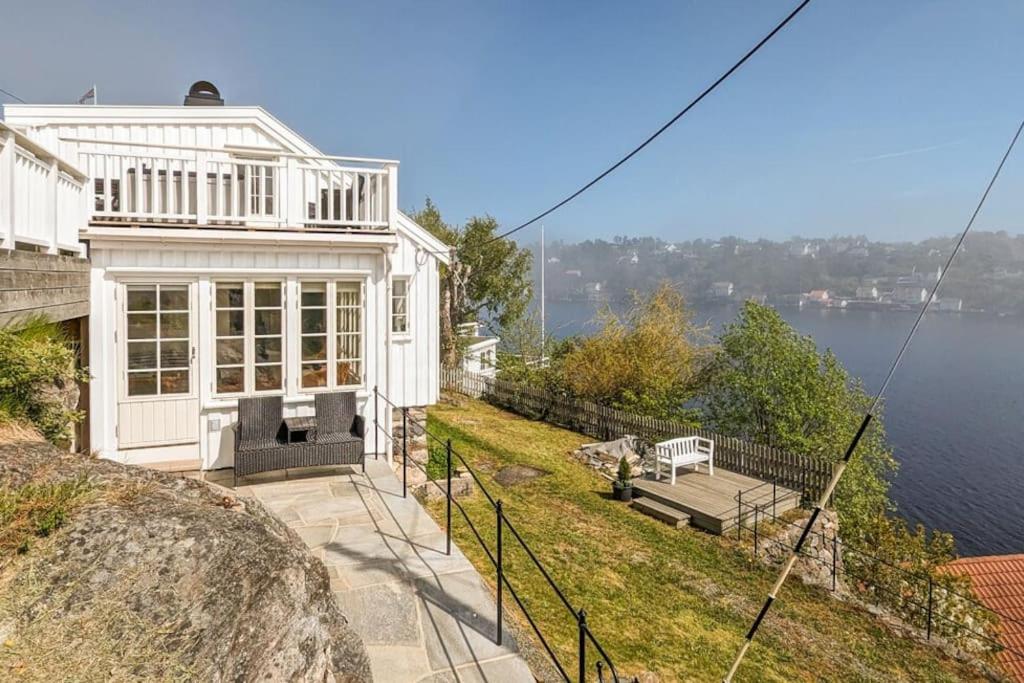 a white house with a view of the water at Feriehus - Arendal ved sjøen in Arendal