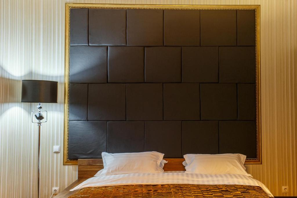 Postel nebo postele na pokoji v ubytování Astor Hotel & Spa