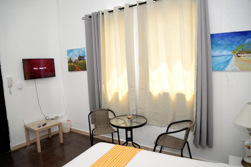 TV a/nebo společenská místnost v ubytování Hostal Mi Rincón