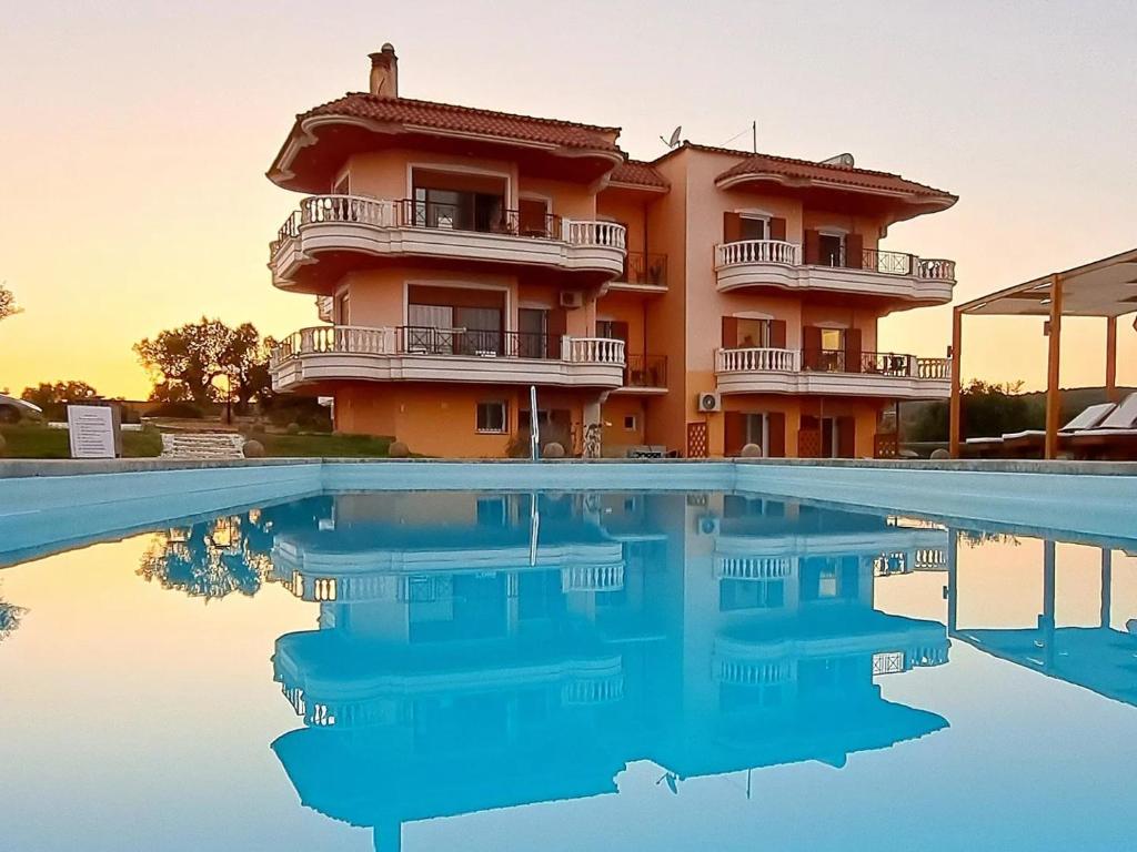 a hotel with a pool in front of a building at Foinikounta view in Finikounta