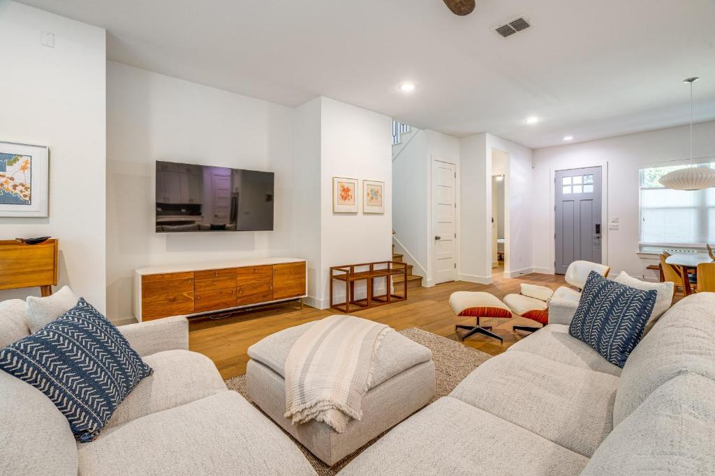 a living room with two couches and a flat screen tv at Spacious Austin Home Near S Congress and Downtown! in Austin