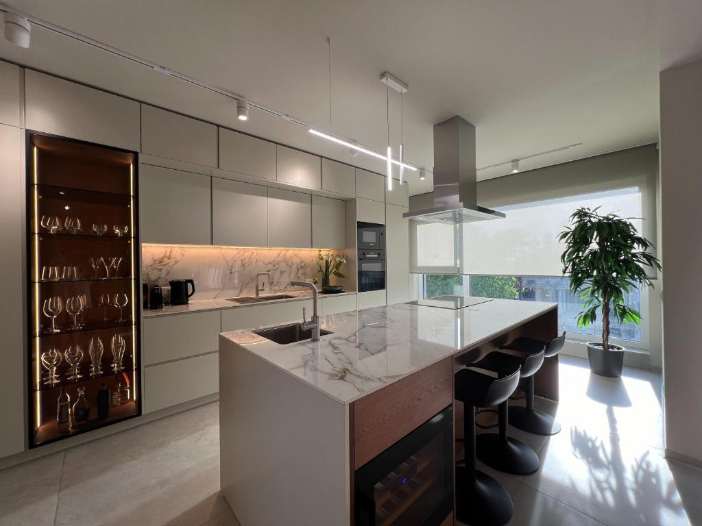 a kitchen with a large island with a counter top at Maneo Lux in Poreč